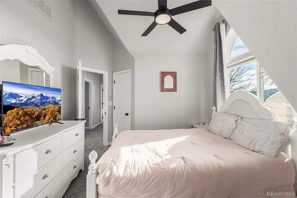 a bedroom with a large bed and a large window