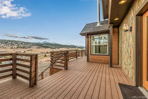 a view of a balcony with wooden floor and outdoor space