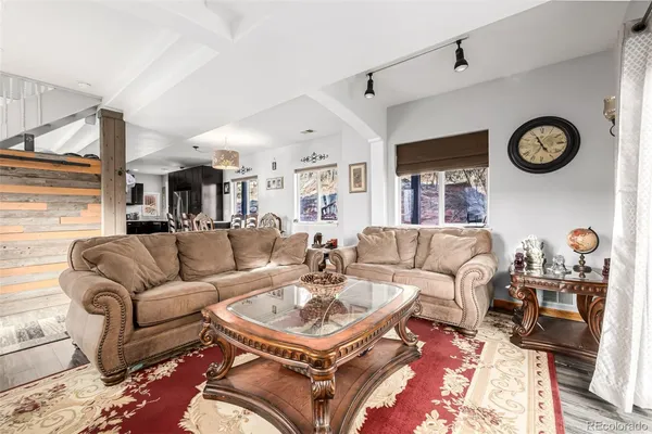 a living room with furniture and a clock