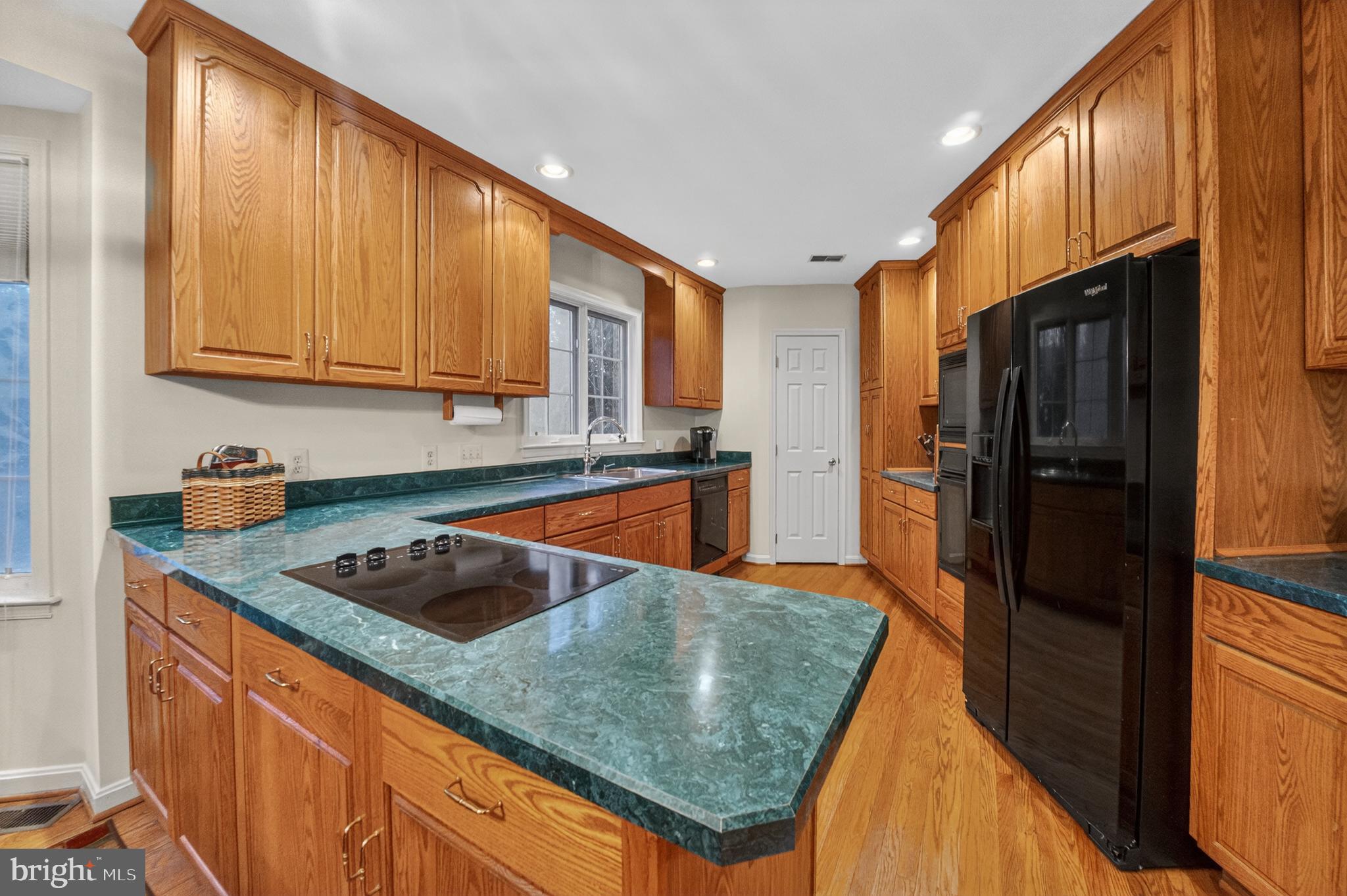 2701 Olney Sandy Spring Road Olney, MD 20832 - Photo 12 of 48 a kitchen with granite countertop a sink a refrigerator and cabinets