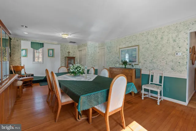 a dining room with furniture and wooden floor