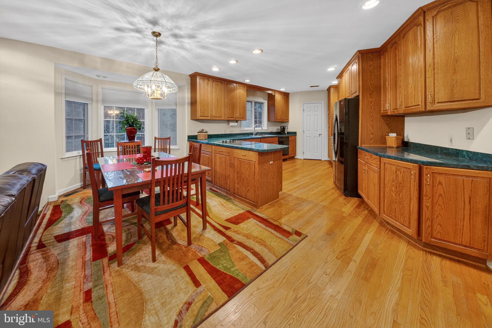 2701 Olney Sandy Spring Road Olney, MD 20832 - Photo 14 of 48 a view of a dining room with furniture a kitchen and chandelier