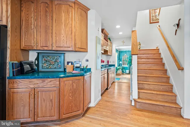 a kitchen with white cabinets and sink