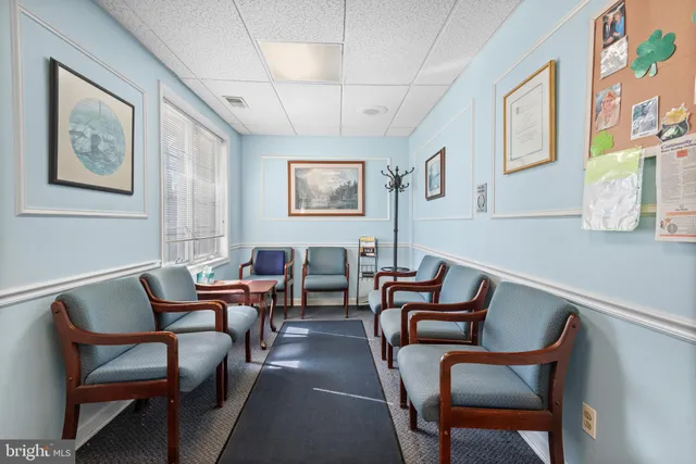 a work place with a book shelf and a window