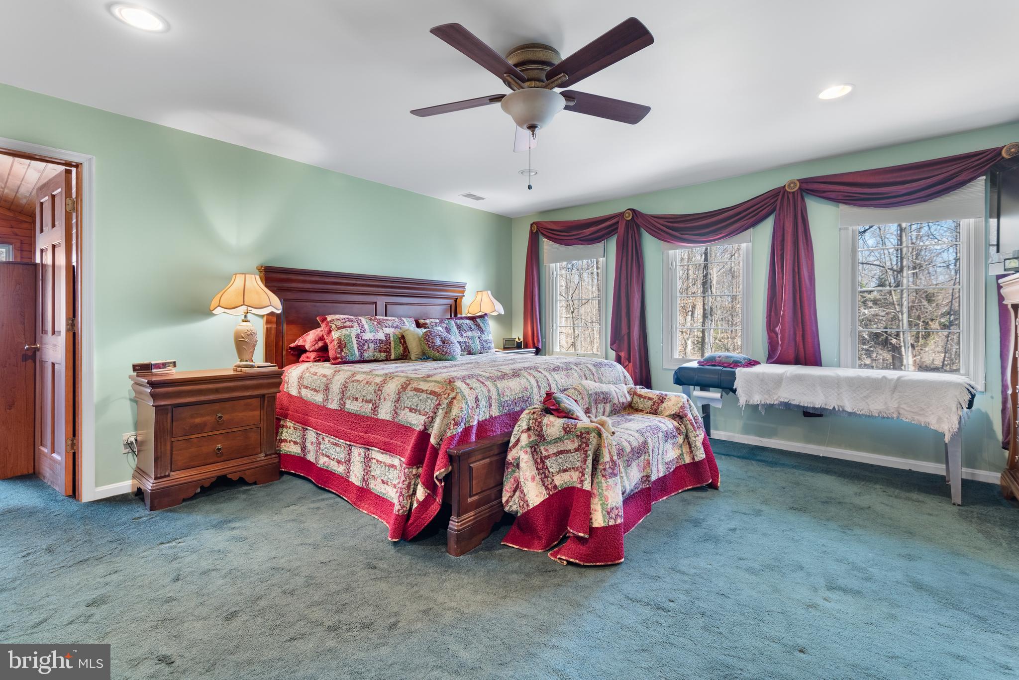 2701 Olney Sandy Spring Road Olney, MD 20832 - Photo 30 of 48 a bedroom with a bed and a chandelier