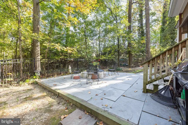 a view of a house with a yard and large tree