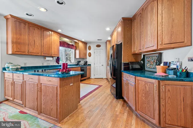 a kitchen with stainless steel appliances granite countertop a refrigerator sink and cabinets