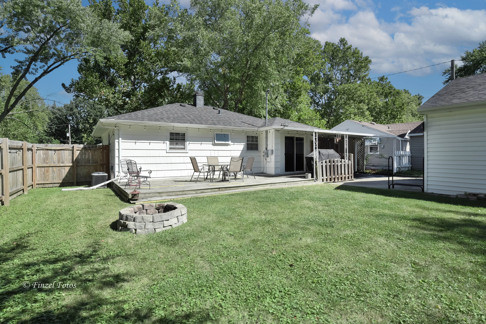 3101 Thrush Lane Rolling Meadows, IL 60008 - Photo 14 of 16 a view of a white house with a yard porch and sitting area