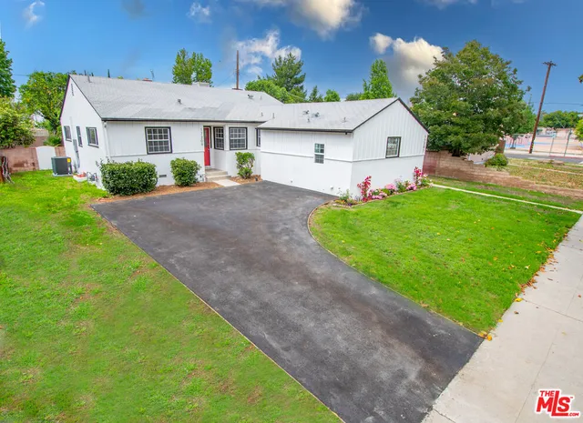a front view of house with yard and outdoor seating