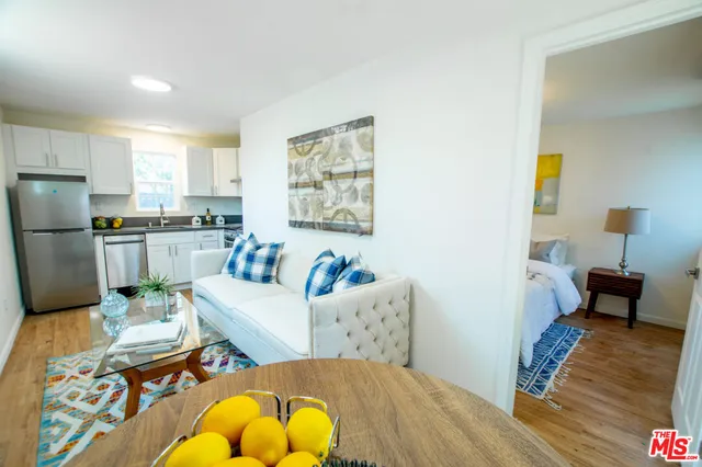 a kitchen with stainless steel appliances granite countertop a refrigerator sink and stove