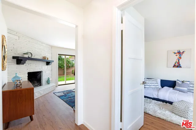 a living room with furniture a rug and a lamp