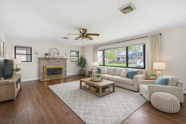a living room with furniture flat screen tv and a fireplace