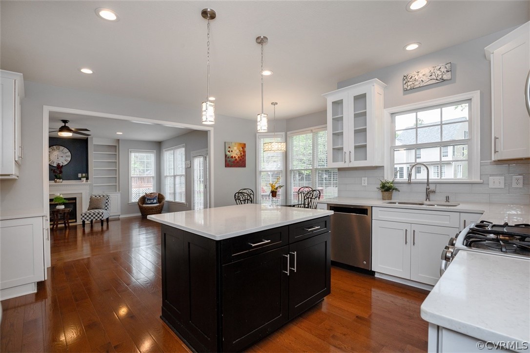 5208 Wheat Ridge Place Glen Allen, VA 23059 - Photo 14 of 45 a kitchen with a stove a sink dishwasher a kitchen island with chairs and wooden floor