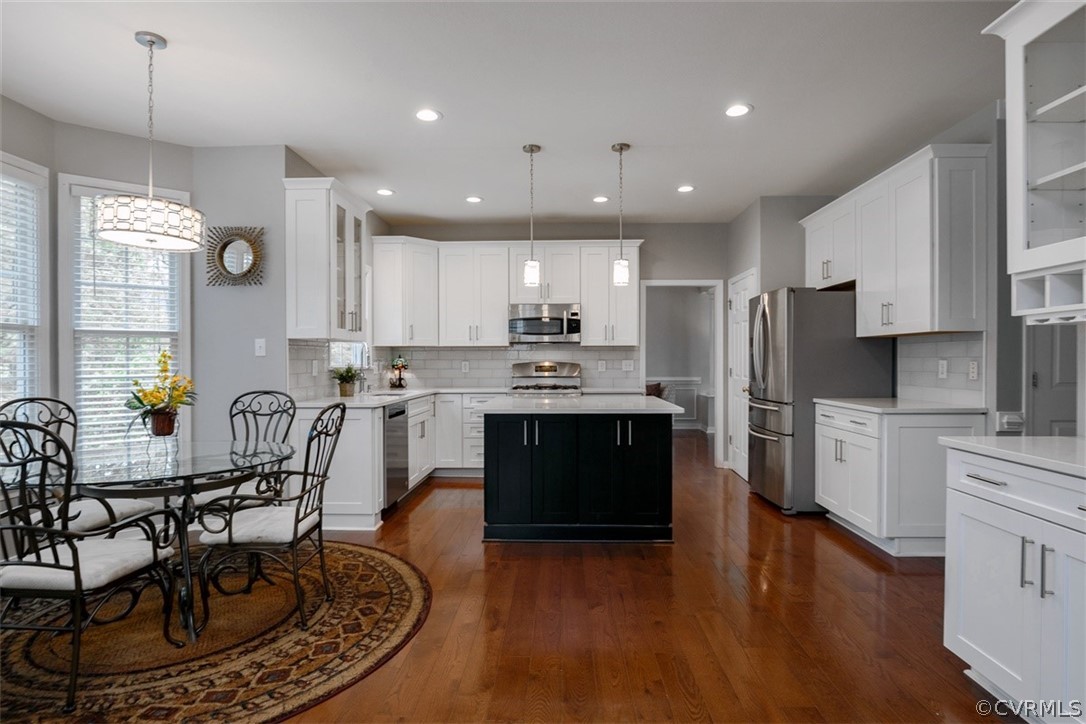 5208 Wheat Ridge Place Glen Allen, VA 23059 - Photo 16 of 45 a kitchen with refrigerator cabinets dining table and chairs