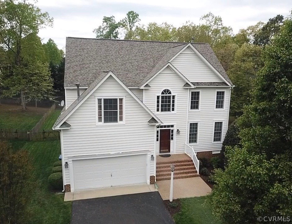 5208 Wheat Ridge Place Glen Allen, VA 23059 - Photo 2 of 45 a view of a white house with a small yard and large trees