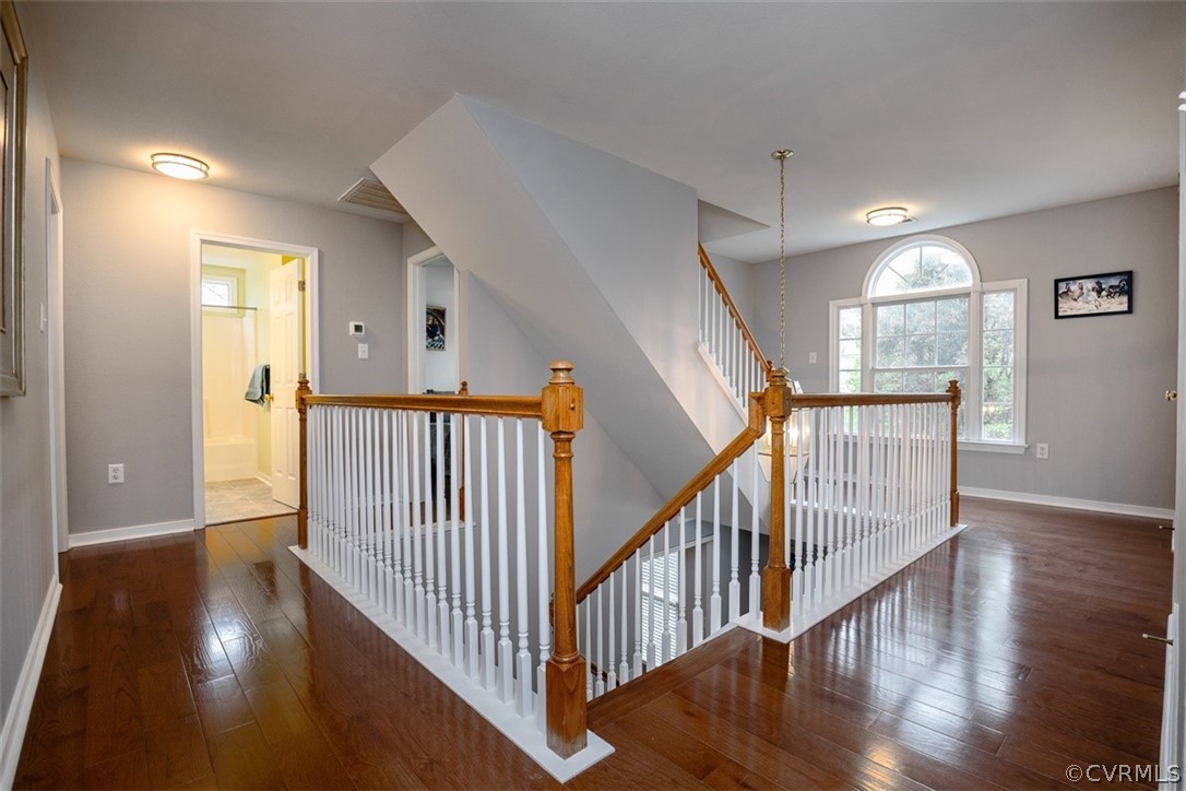 5208 Wheat Ridge Place Glen Allen, VA 23059 - Photo 23 of 45 a view of a hallway view with wooden floor and staircase