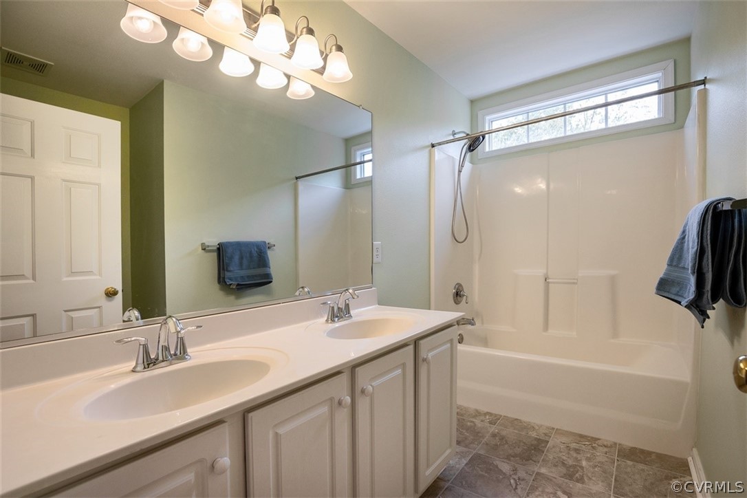 5208 Wheat Ridge Place Glen Allen, VA 23059 - Photo 27 of 45 a bathroom with a tub a sink and a mirror