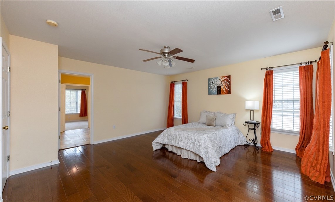 5208 Wheat Ridge Place Glen Allen, VA 23059 - Photo 28 of 45 a bedroom with a bed and wooden floor