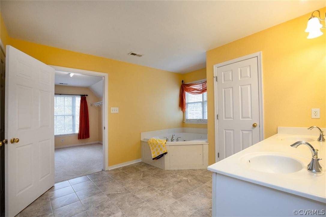 5208 Wheat Ridge Place Glen Allen, VA 23059 - Photo 30 of 45 a view of a bathroom with a sink and a tub