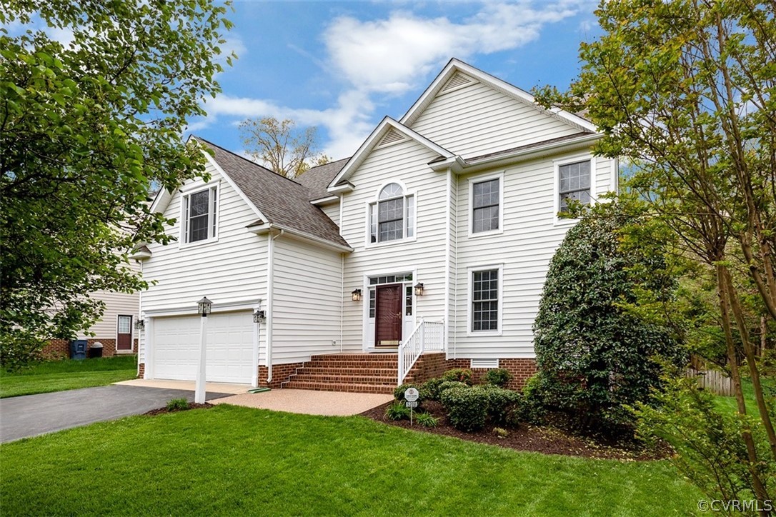 5208 Wheat Ridge Place Glen Allen, VA 23059 - Photo 3 of 45 a front view of a house with a yard and garage