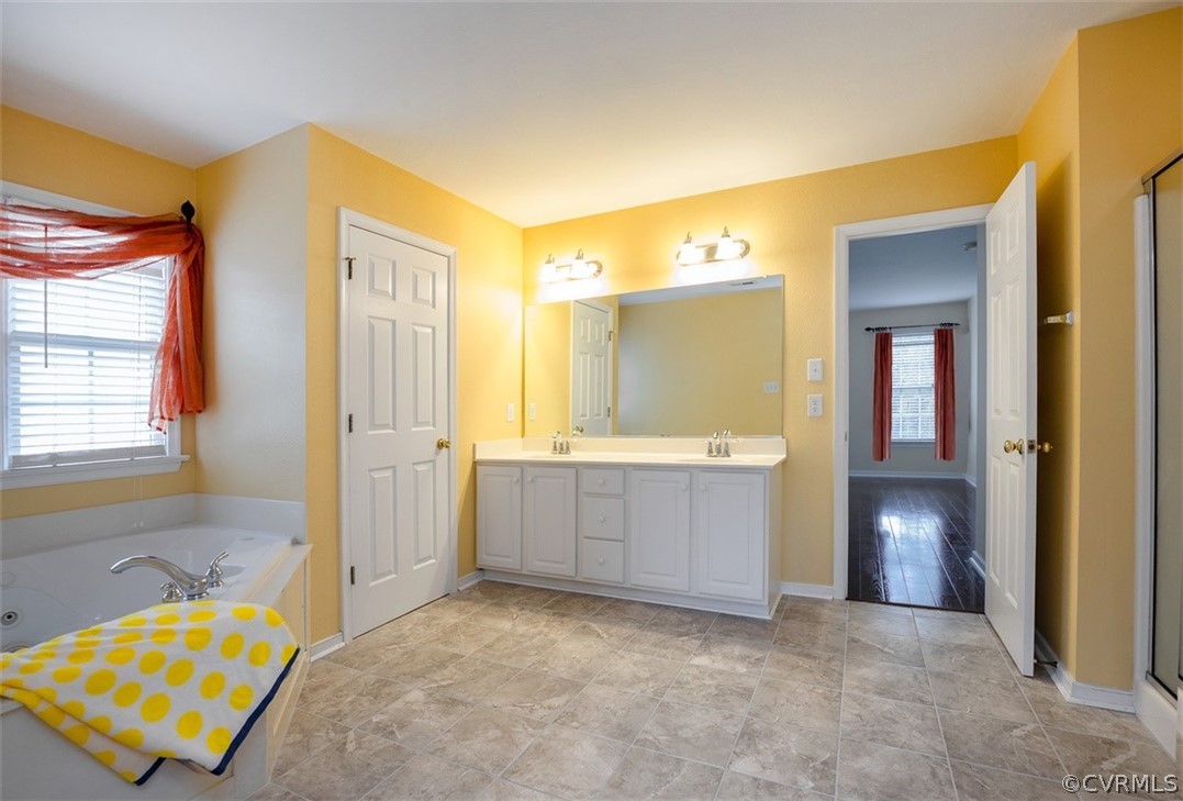 5208 Wheat Ridge Place Glen Allen, VA 23059 - Photo 31 of 45 a bathroom with a tub sink and mirror
