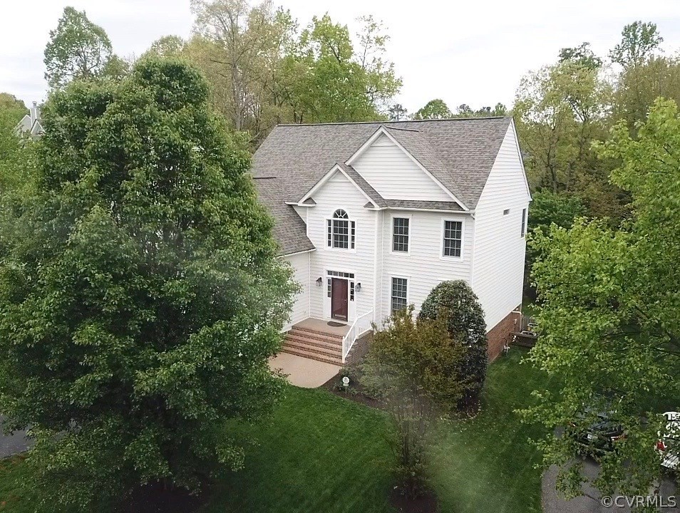 5208 Wheat Ridge Place Glen Allen, VA 23059 - Photo 42 of 45 a aerial view of a house with yard and trees in the background