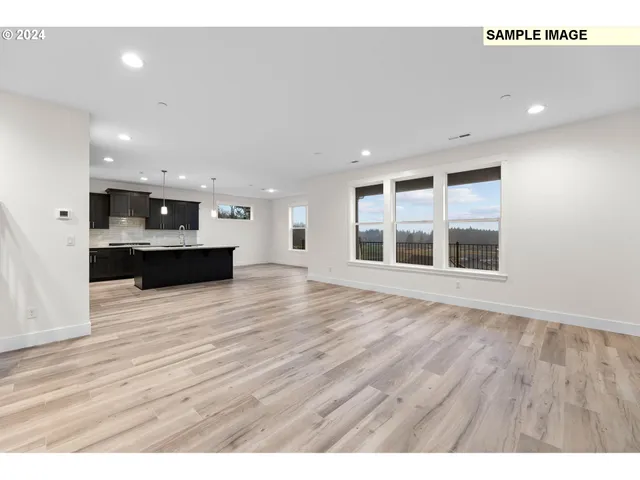 a kitchen with stainless steel appliances granite countertop a sink refrigerator and microwave