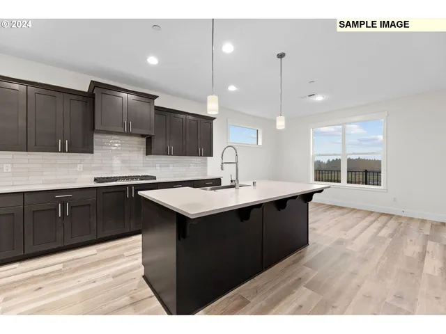 a large kitchen with stainless steel appliances granite countertop a large counter top and a stove