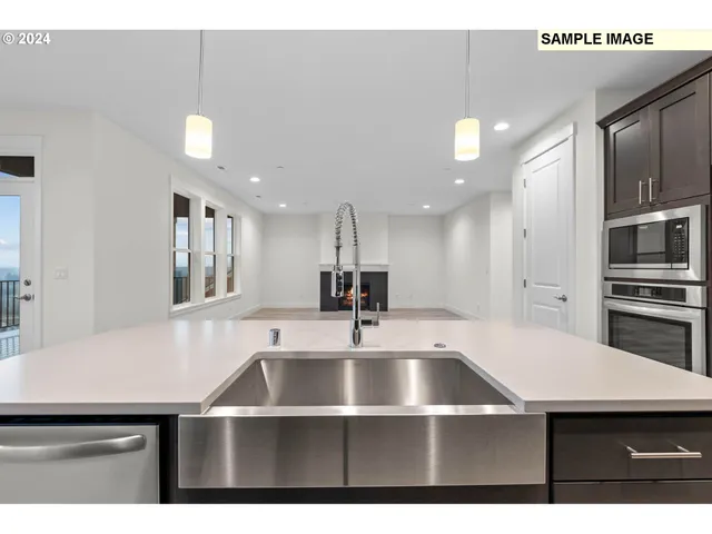 a kitchen with a sink a window and chairs