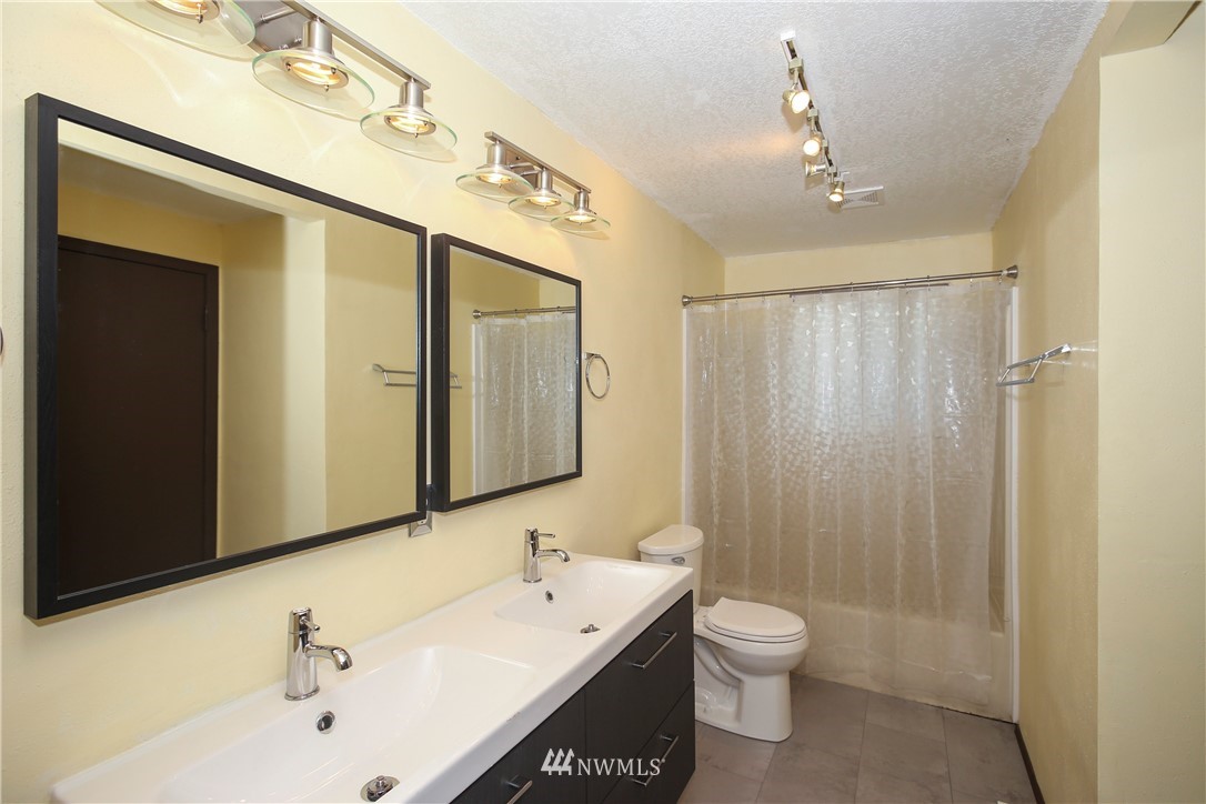 2521 173rd Place Southeast Bothell, WA 98012 - Photo 12 of 21 a bathroom with a toilet a sink a mirror and vanity