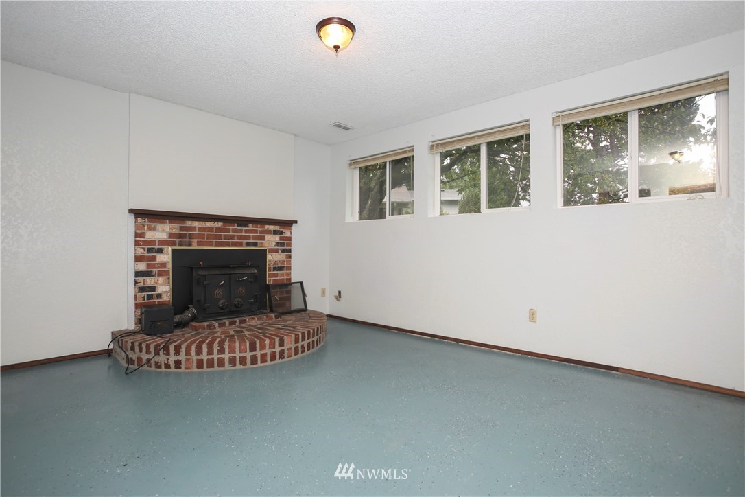 2521 173rd Place Southeast Bothell, WA 98012 - Photo 13 of 21 a living room with furniture and a fireplace