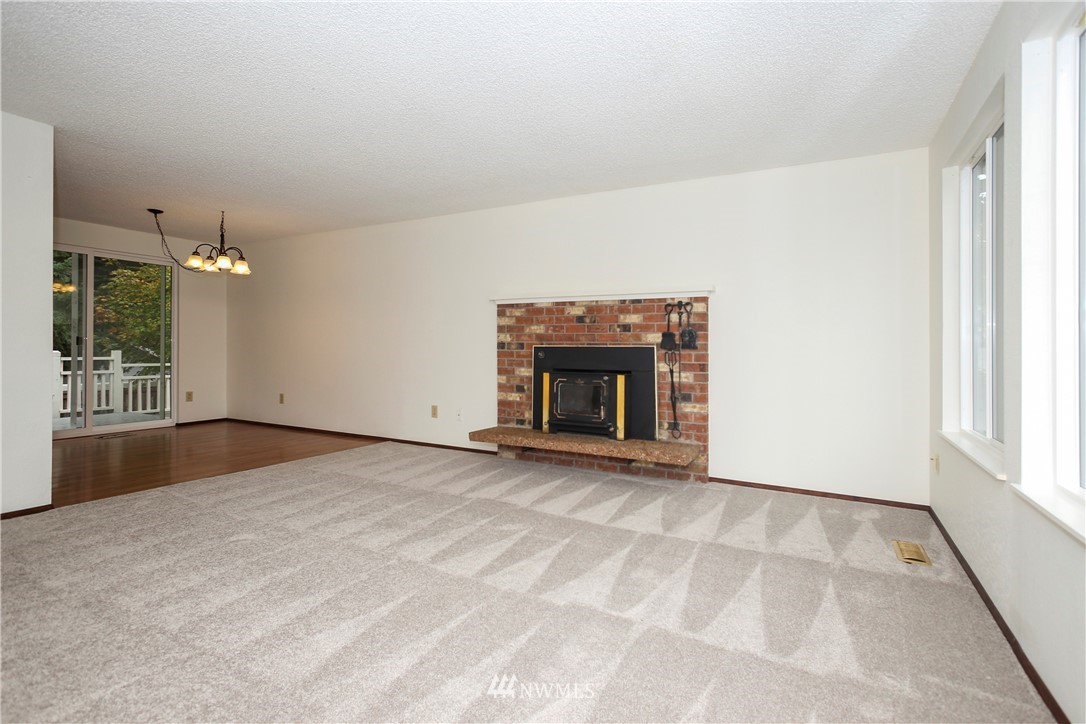 2521 173rd Place Southeast Bothell, WA 98012 - Photo 4 of 21 en empty room with windows and fireplace