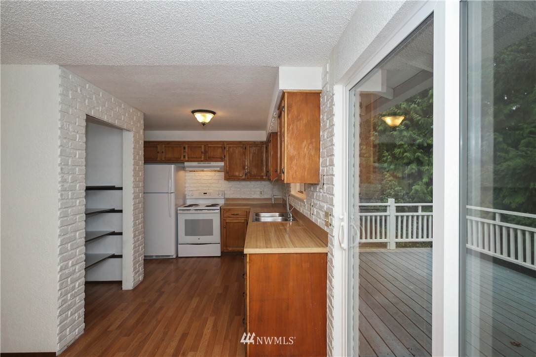 2521 173rd Place Southeast Bothell, WA 98012 - Photo 7 of 21 a room with wooden floors and a view of bedroom