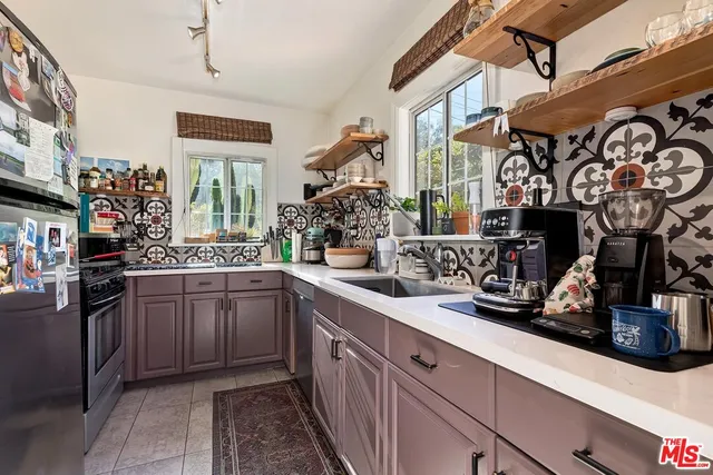 a kitchen with stainless steel appliances granite countertop a sink and cabinets