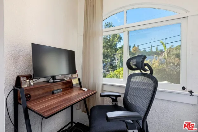 a living room with furniture and a floor to ceiling window