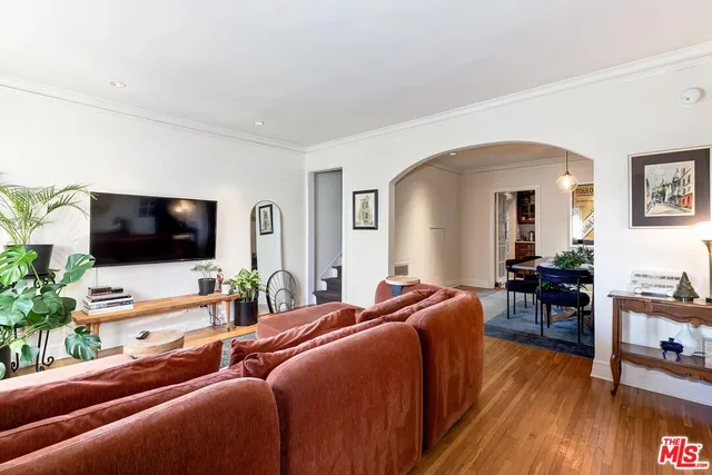 a kitchen with a refrigerator a stove a sink and a dining table