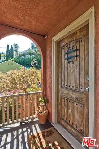 a view of a balcony with chair and wooden floor