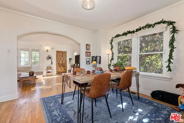 a view of a livingroom with furniture window and wooden floor