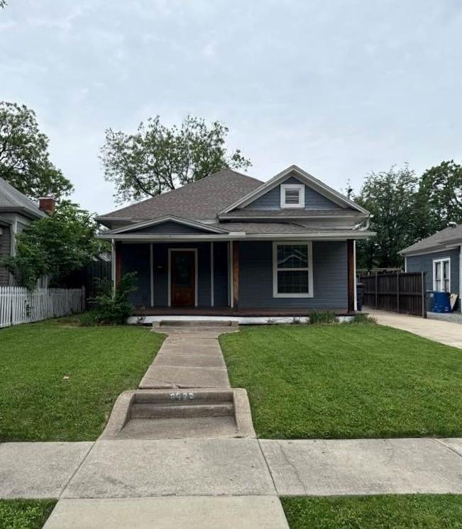 Single-story residence featuring a covered front porch with wood columns, a gabled roofline, and a wood entry door