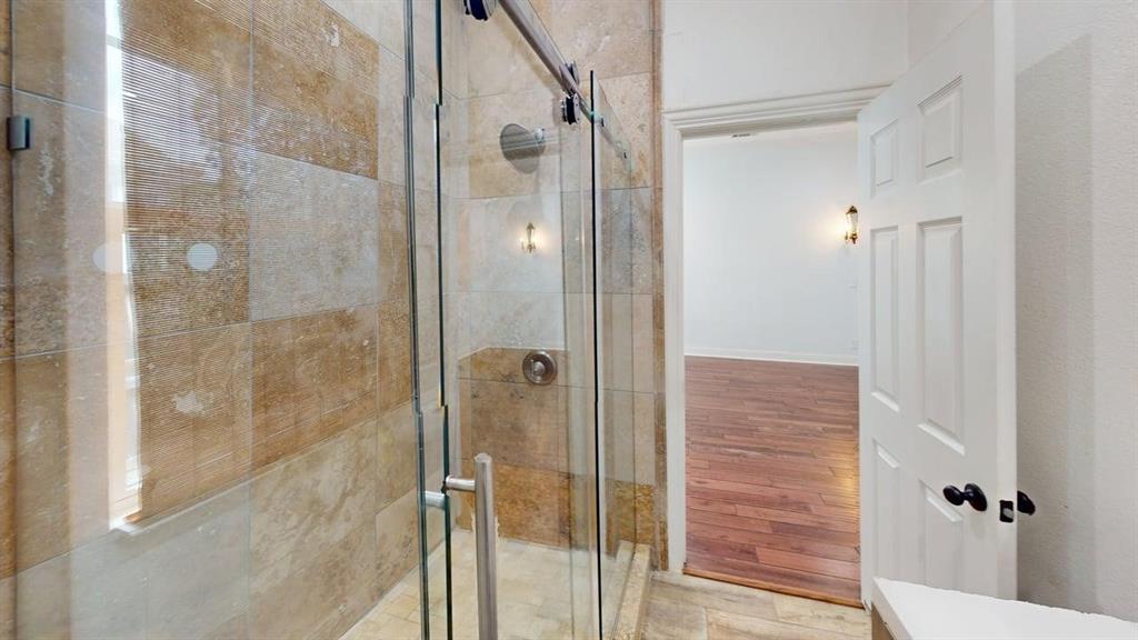 4523 Sycamore Street Dallas, TX 75204 - Photo 12 of 16 Shower with glass enclosure, brushed nickel hardware, and full-height tile surround