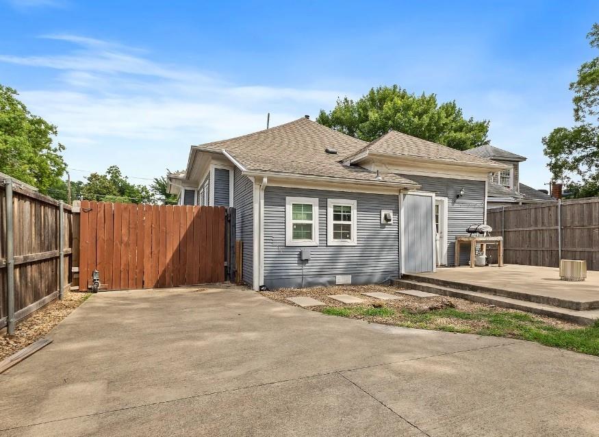 4523 Sycamore Street Dallas, TX 75204 - Photo 15 of 16 Property exterior featuring horizontal siding, a gabled roof, and white-framed windows
