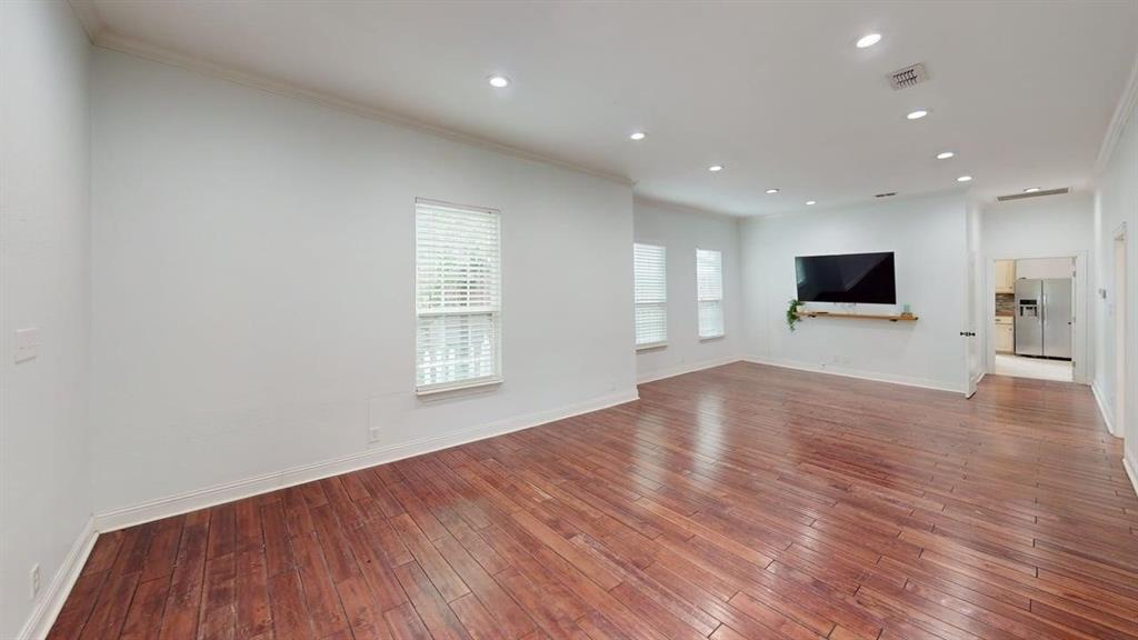 4523 Sycamore Street Dallas, TX 75204 - Photo 4 of 16 Spacious living area featuring rich wood-finish flooring, recessed lighting, multiple windows with blinds, and white baseboards