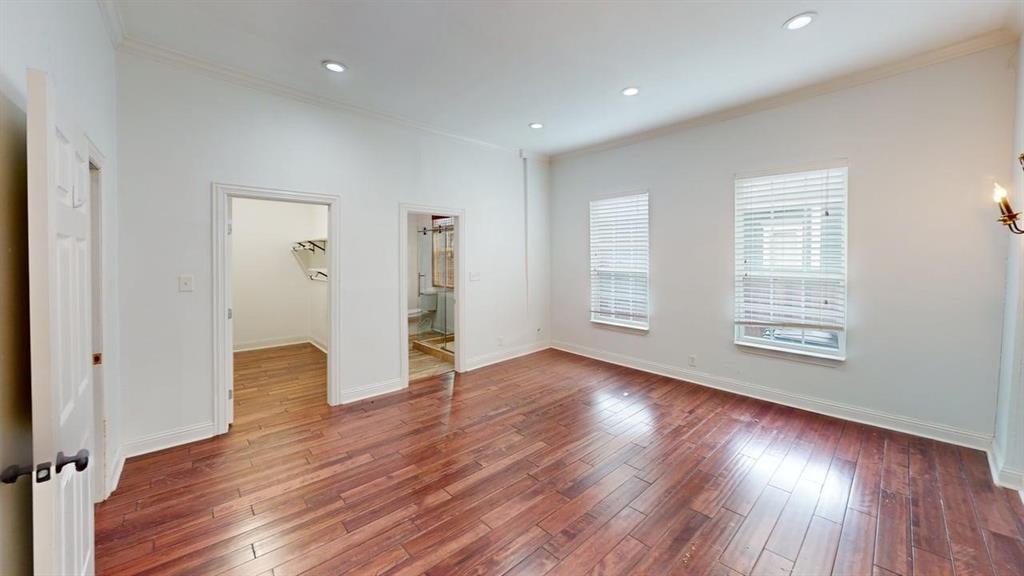 4523 Sycamore Street Dallas, TX 75204 - Photo 8 of 16 Spacious room featuring rich wood-finish flooring, recessed lighting, crown molding, and two windows with blinds