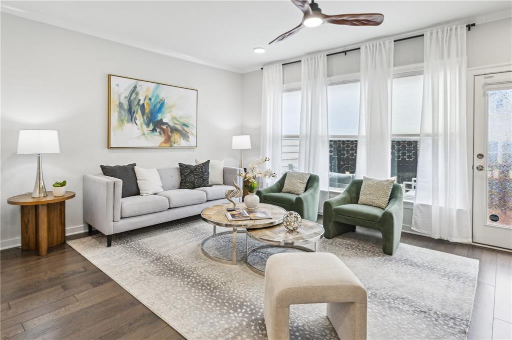 a living room with furniture and a painting on the wall