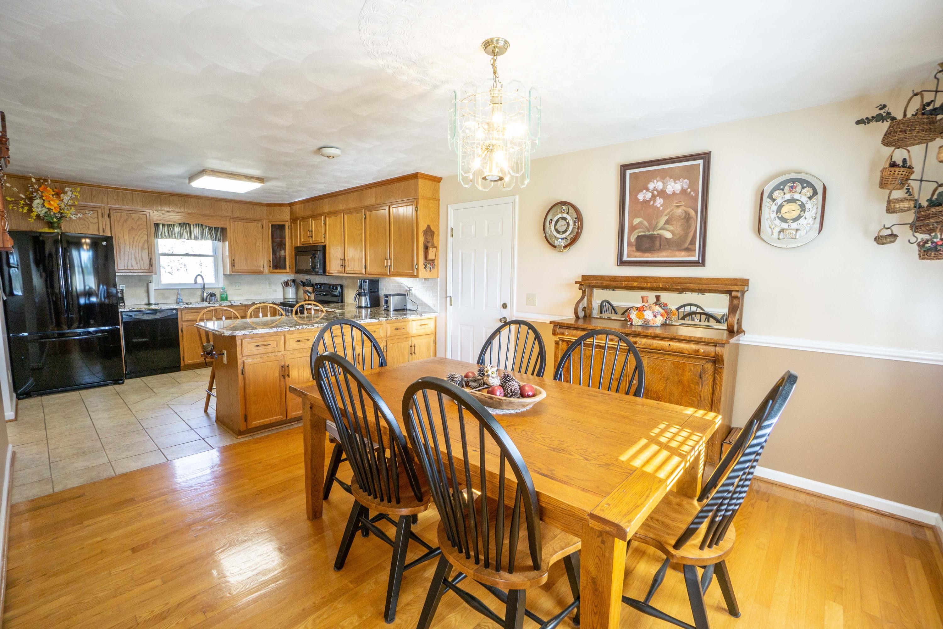 218 Oak Ridge Court Blue Ridge, VA 24064 - Photo 11 of 48 a view of a dining room with furniture and wooden floor