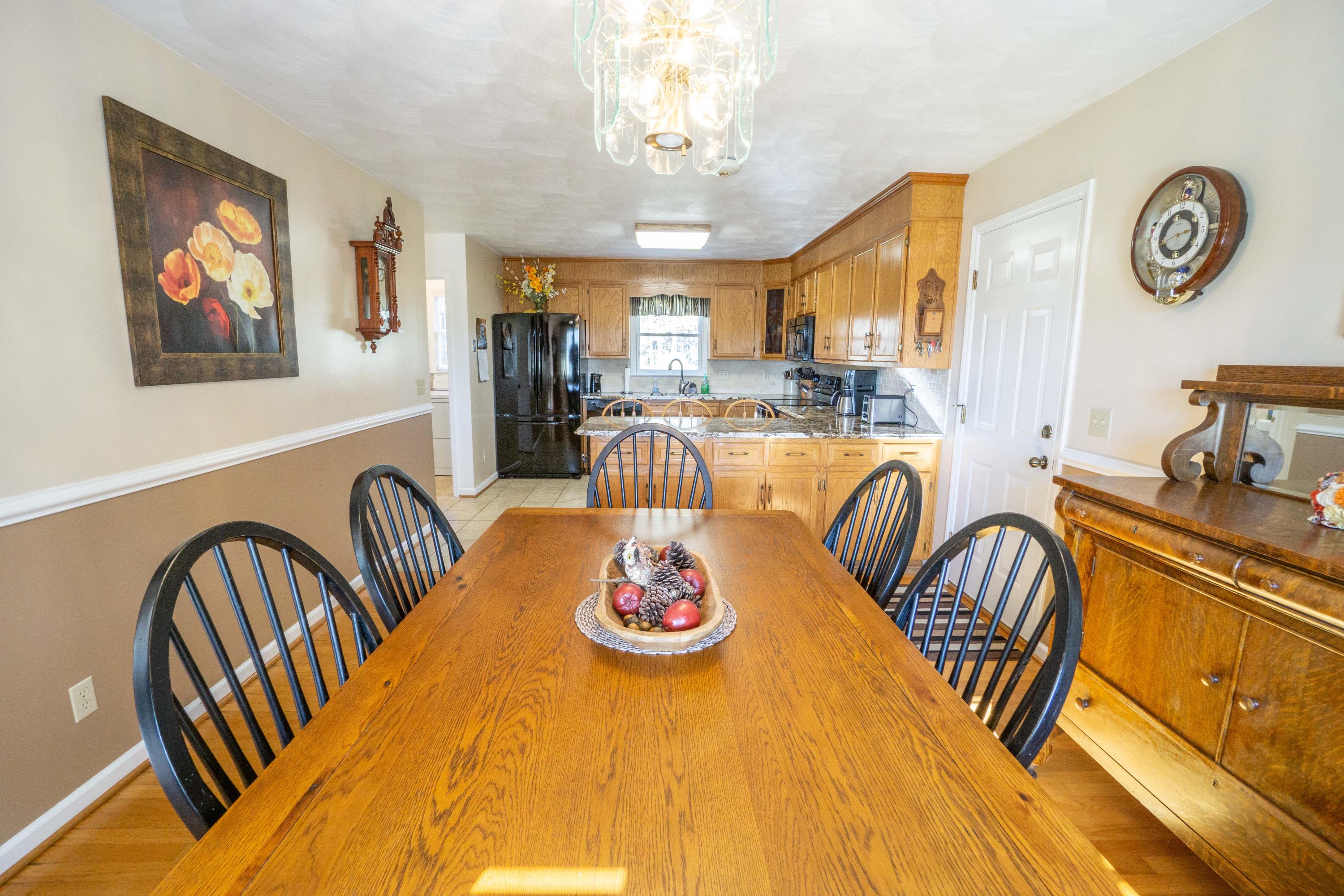 218 Oak Ridge Court Blue Ridge, VA 24064 - Photo 12 of 48 a dining room with furniture a chandelier and a rug