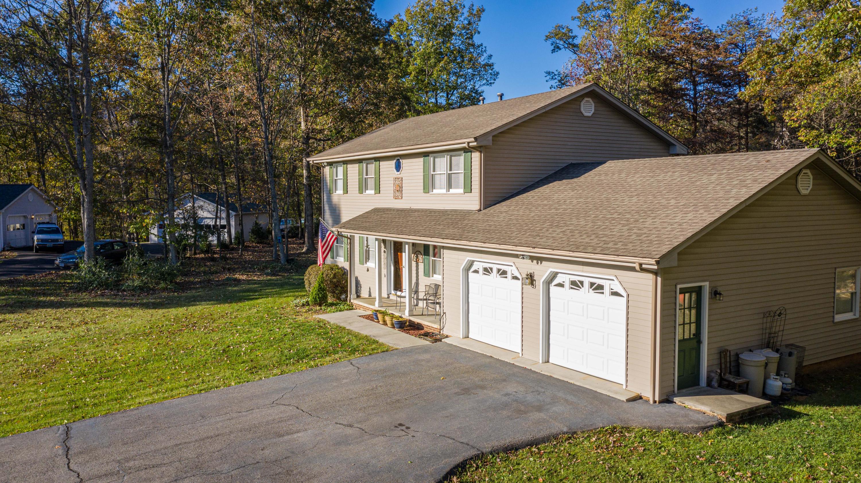 218 Oak Ridge Court Blue Ridge, VA 24064 - Photo 3 of 48 a front view of a house with garden