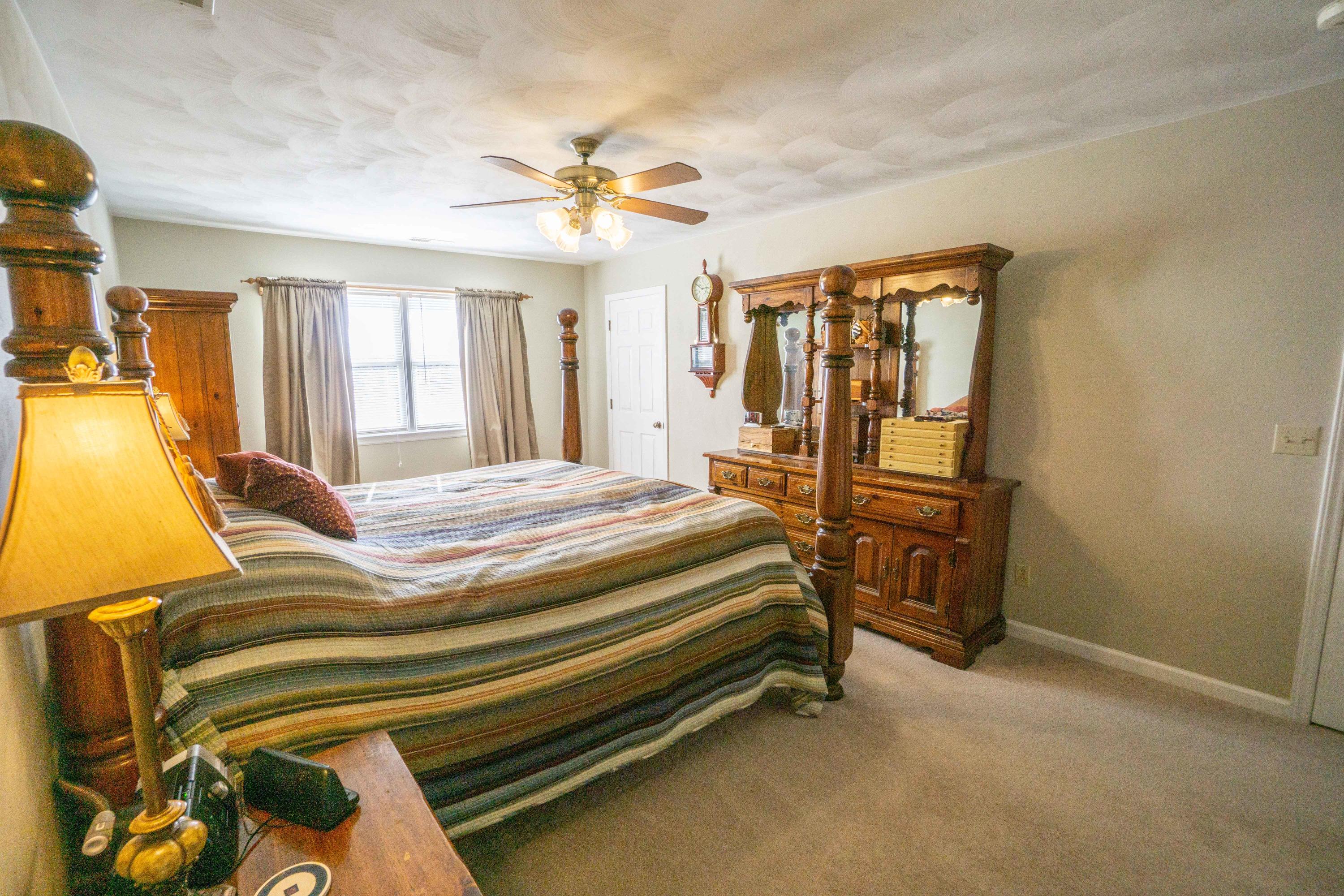 218 Oak Ridge Court Blue Ridge, VA 24064 - Photo 24 of 48 a bedroom with a bed and wooden floor
