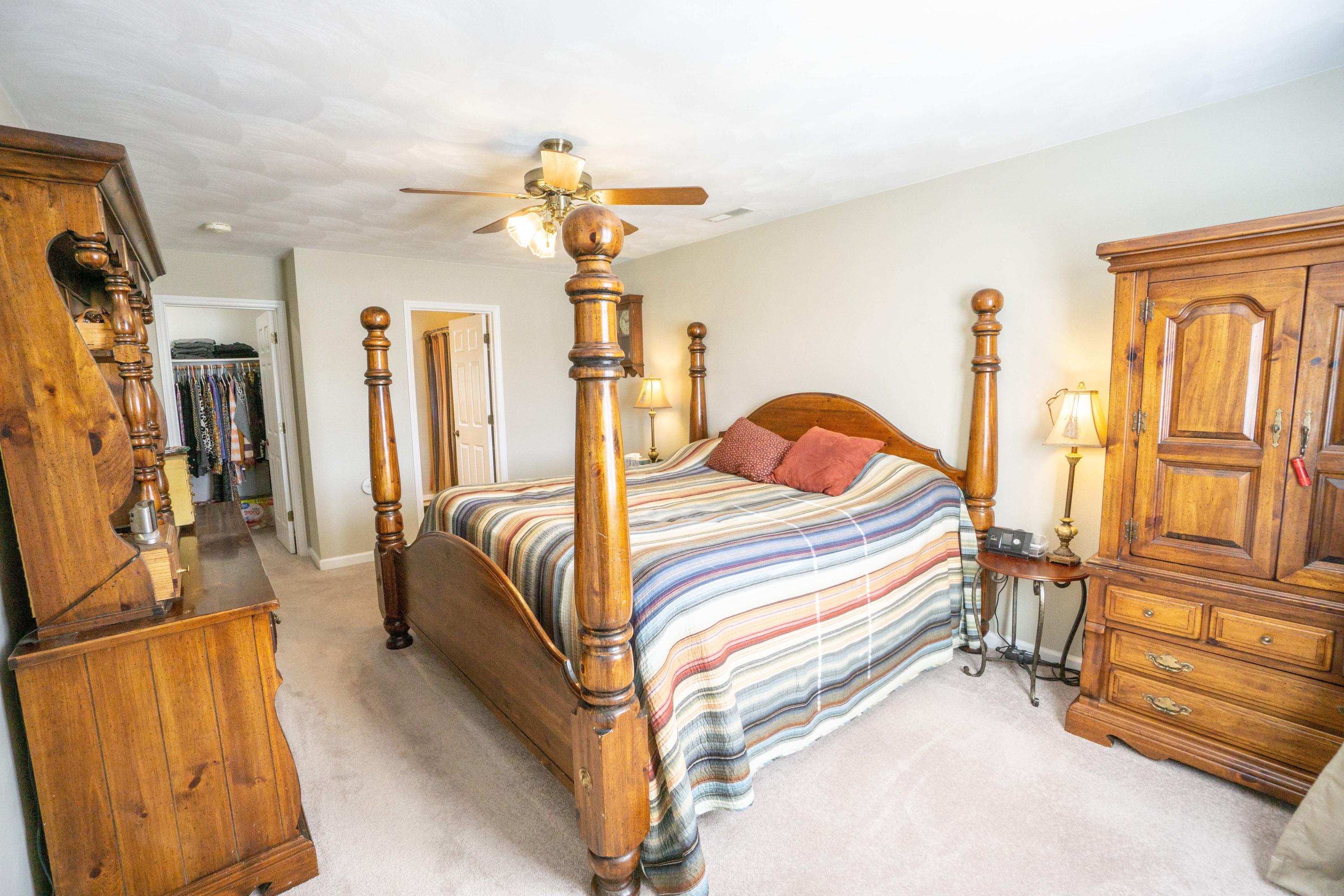 218 Oak Ridge Court Blue Ridge, VA 24064 - Photo 25 of 48 a bedroom with a bed and wooden floor