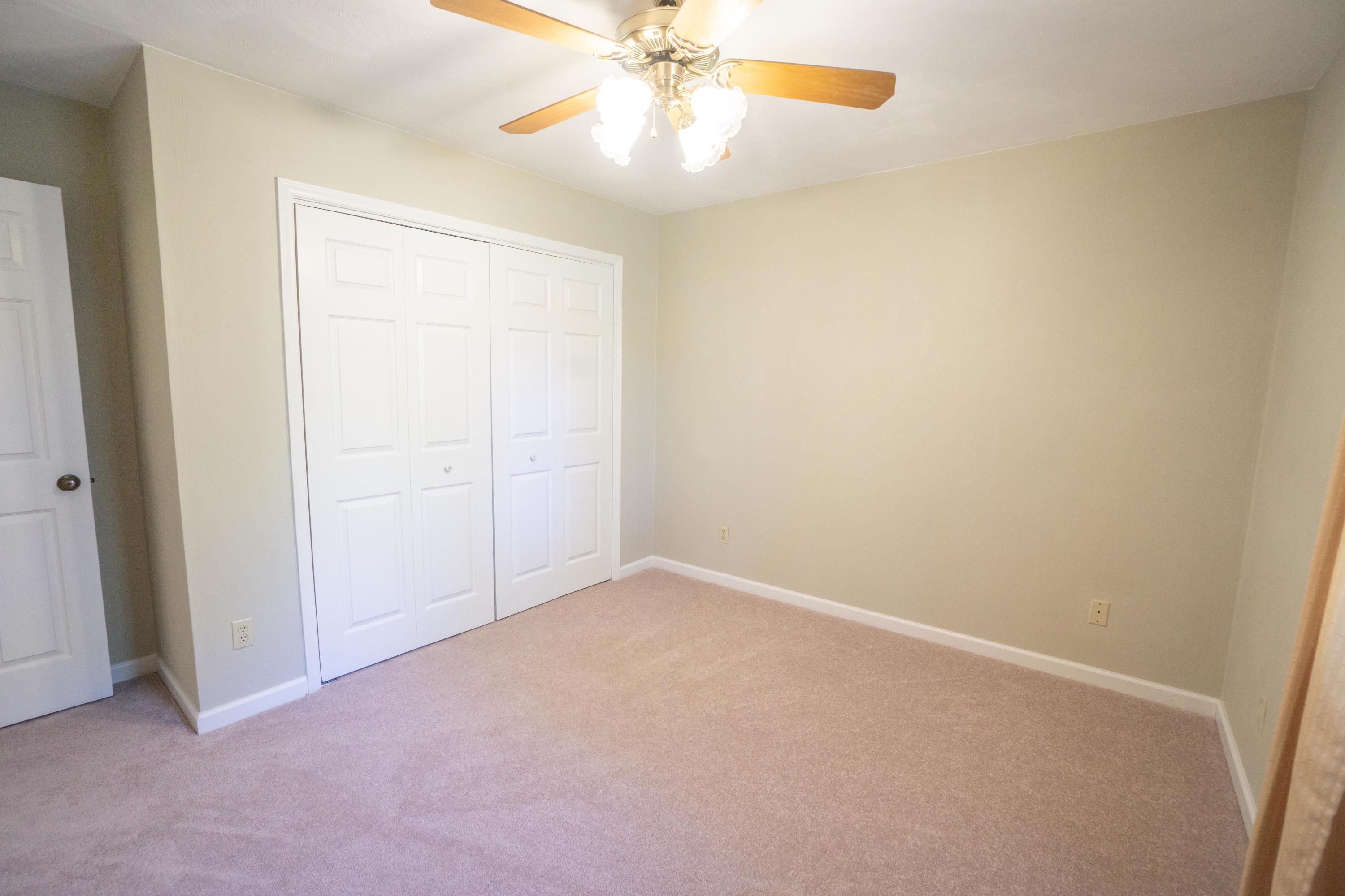218 Oak Ridge Court Blue Ridge, VA 24064 - Photo 31 of 48 an empty room with a ceiling fan and a window